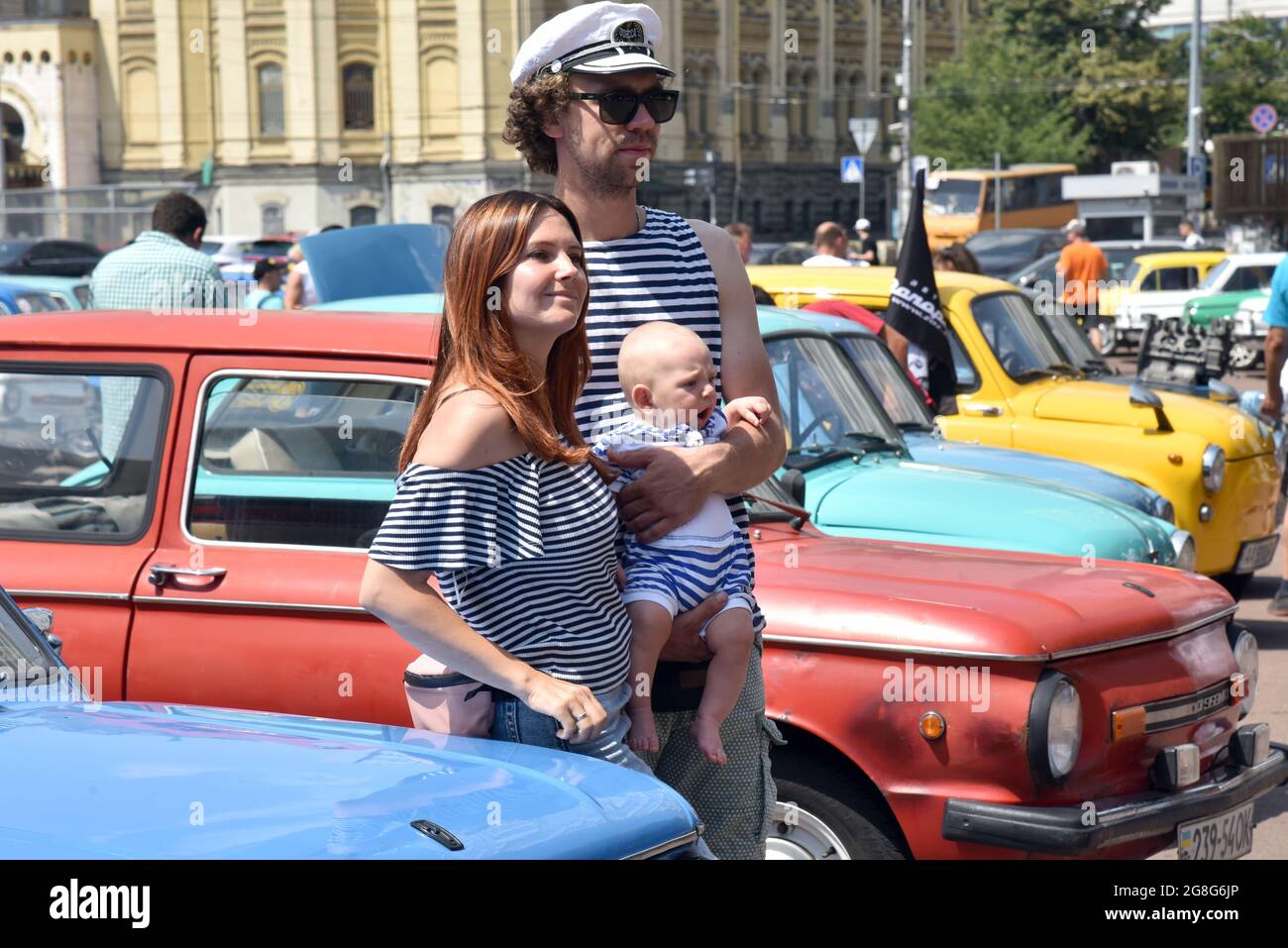 Non Exclusive: KYIV, UKRAINE - JULY 17, 2021 - A man and a woman with a baby pose for a  photo during the show of 1960-1994 ZAZ cars celebrating 20 ye Stock Photo