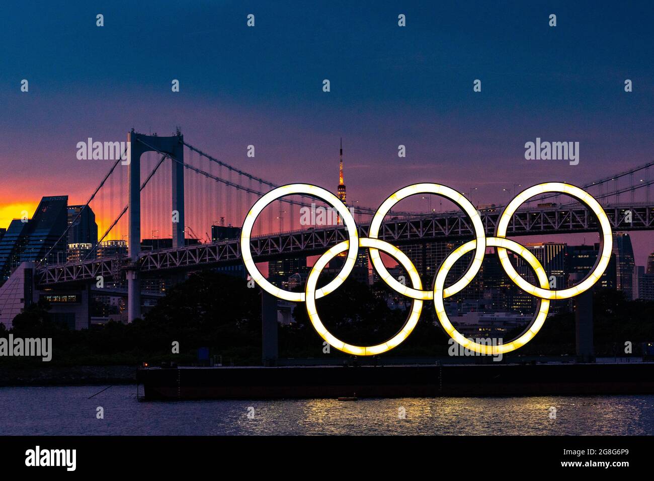 Tokyo, Japan. 20th July, 2021. The Olympic rings floating on a barge in Tokyo Bay in front of the Rainbow Bridge at twilight before the start of the Tokyo Olympics, in Tokyo, Japan on Tuesday, July 20, 2021. Photo by Richard Ellis/UPI. Credit: UPI/Alamy Live News Stock Photo