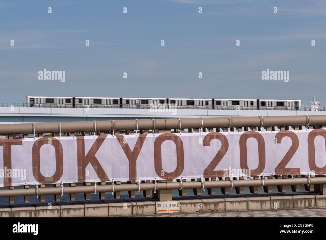Tokyo, Japan. 20th July, 2021. A commuter train passes a Tokyo 2020 banner before the start of the Tokyo Olympics, in Tokyo, Japan on Tuesday, July 20, 2021. Photo by Richard Ellis/UPI. Credit: UPI/Alamy Live News Stock Photo