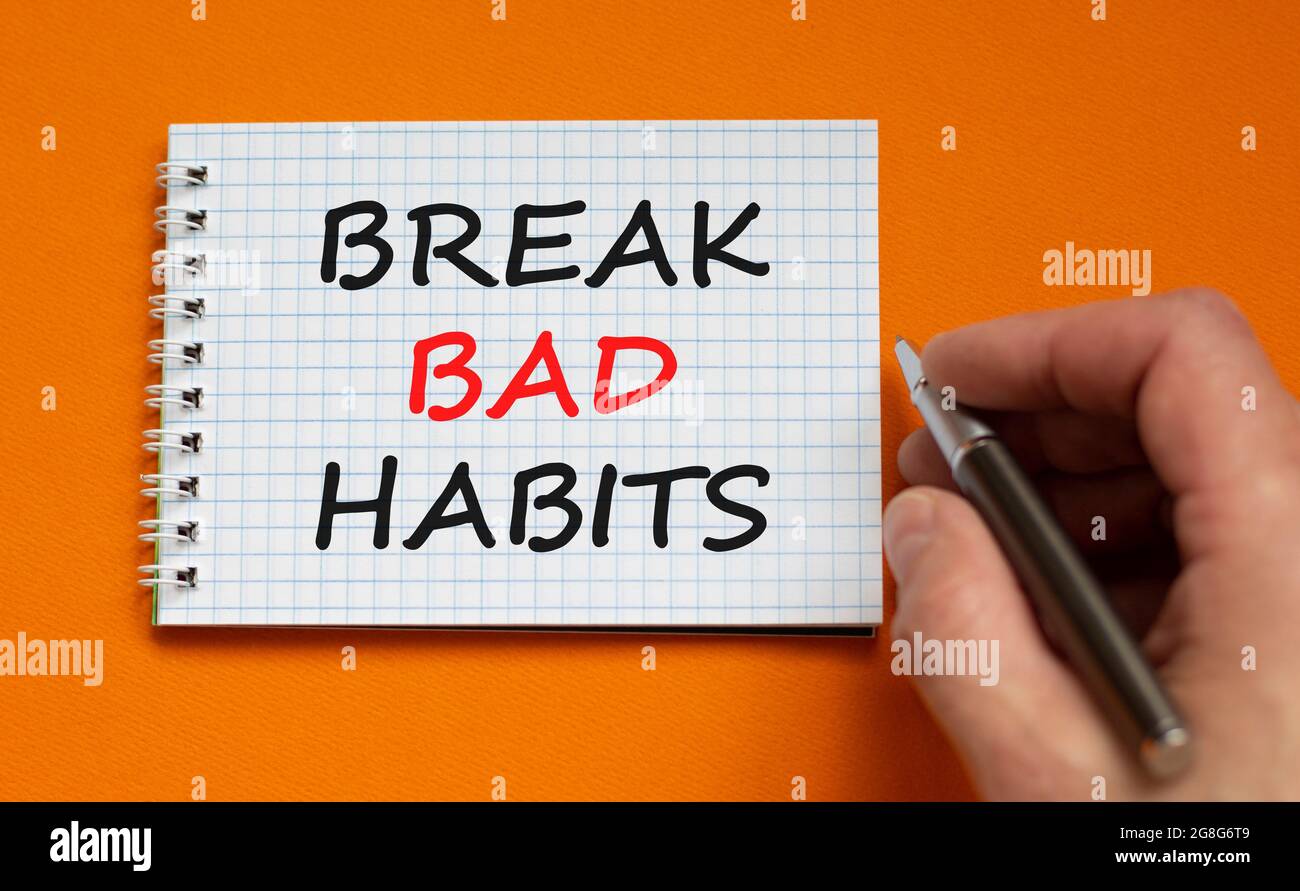 Break bad habits symbol. Businessman writing words 'Break bad habits ...