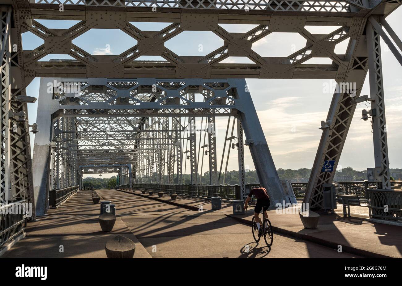 Cyclist on the John Seigenthaler pedestrian bridge or Shelby street crossing leaving downtown Nashville Tennessee Stock Photo