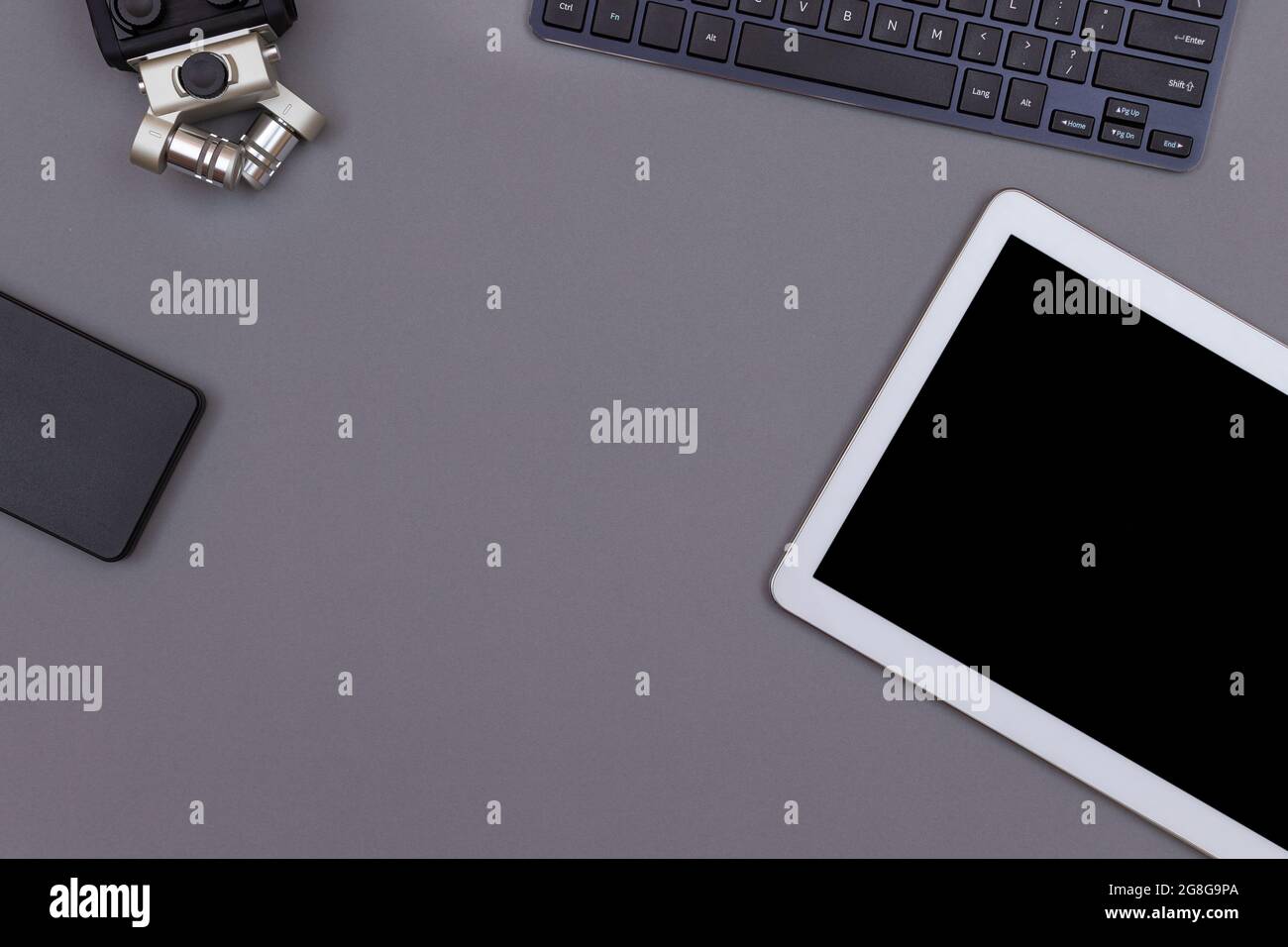 Top View of Workplace. Digital Gadgets Lying on Grey Table - Flat Lay Stock Photo