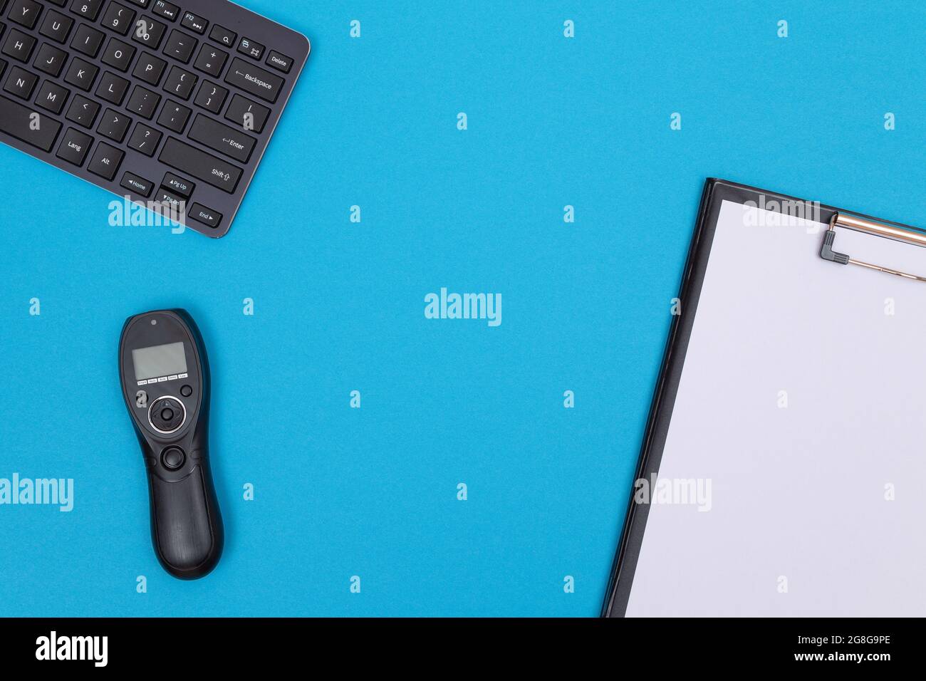 Office Workplace with Digital Gadgets Lying on Blue Table - Flat Lay Stock Photo