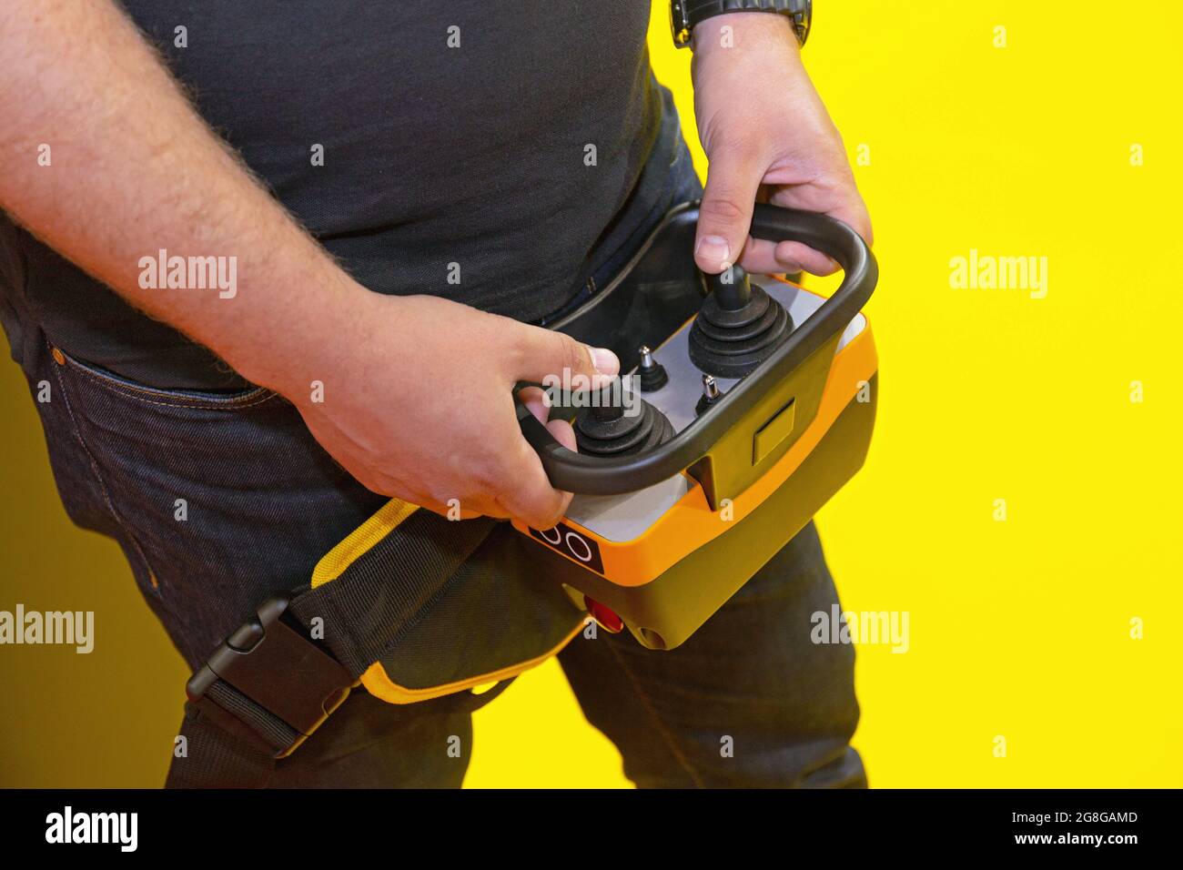 Worker Holding Remote Control With Joysticks for Construction Machinery Stock Photo