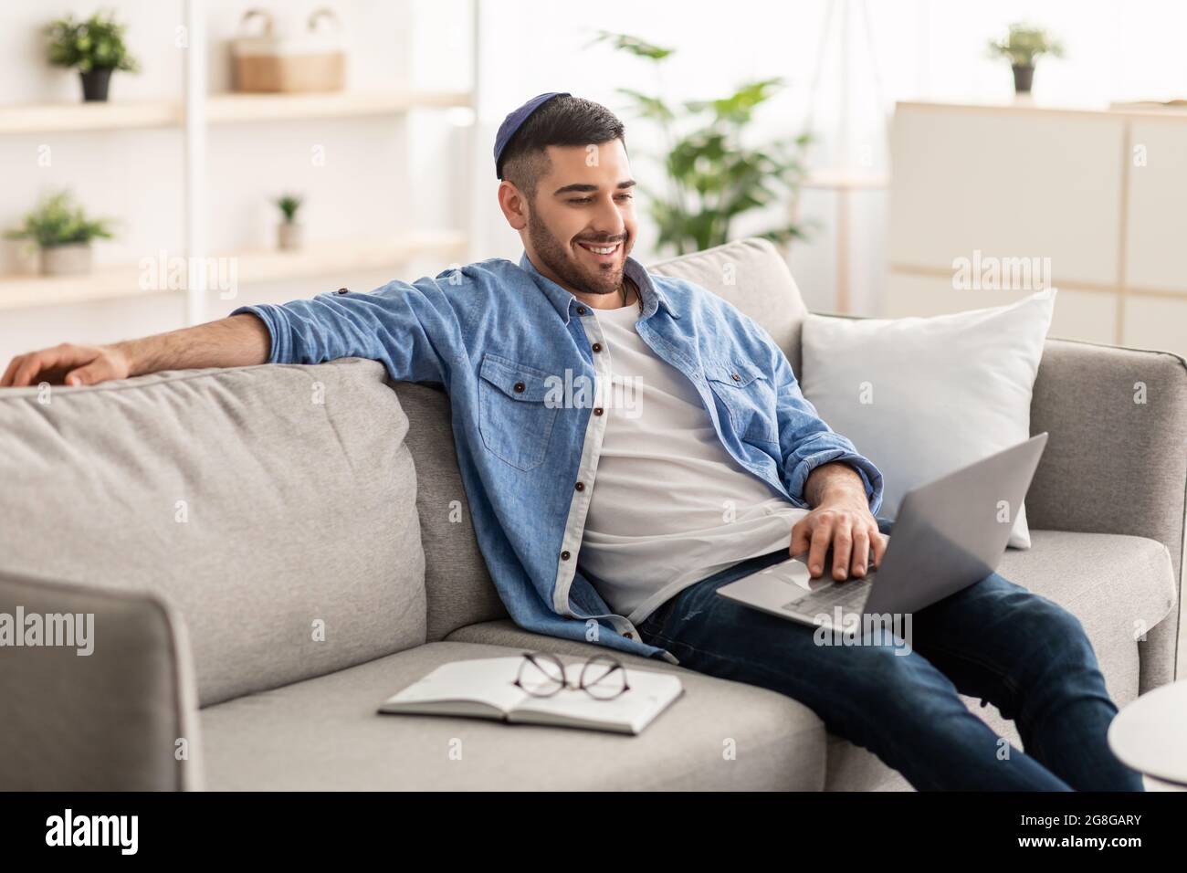 Smiling jewish man watching video on computer Stock Photo