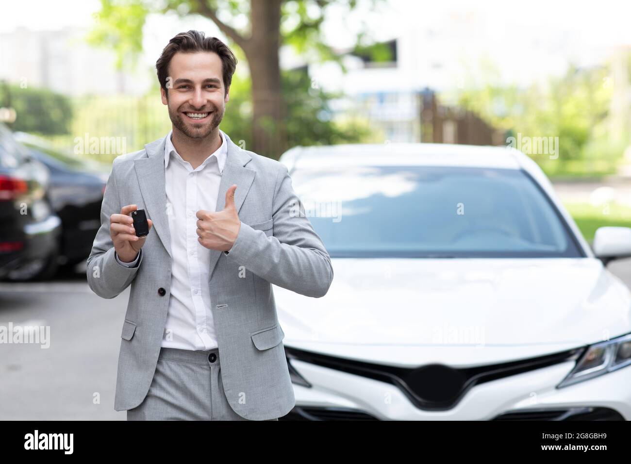 Excited man, hold keys to his new own automobile Stock Photo