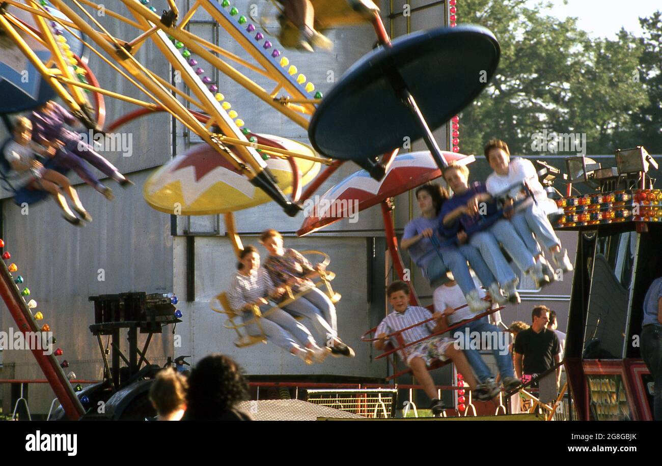 1990s, historical, people enjoying a chair amusement ride outside at a ...