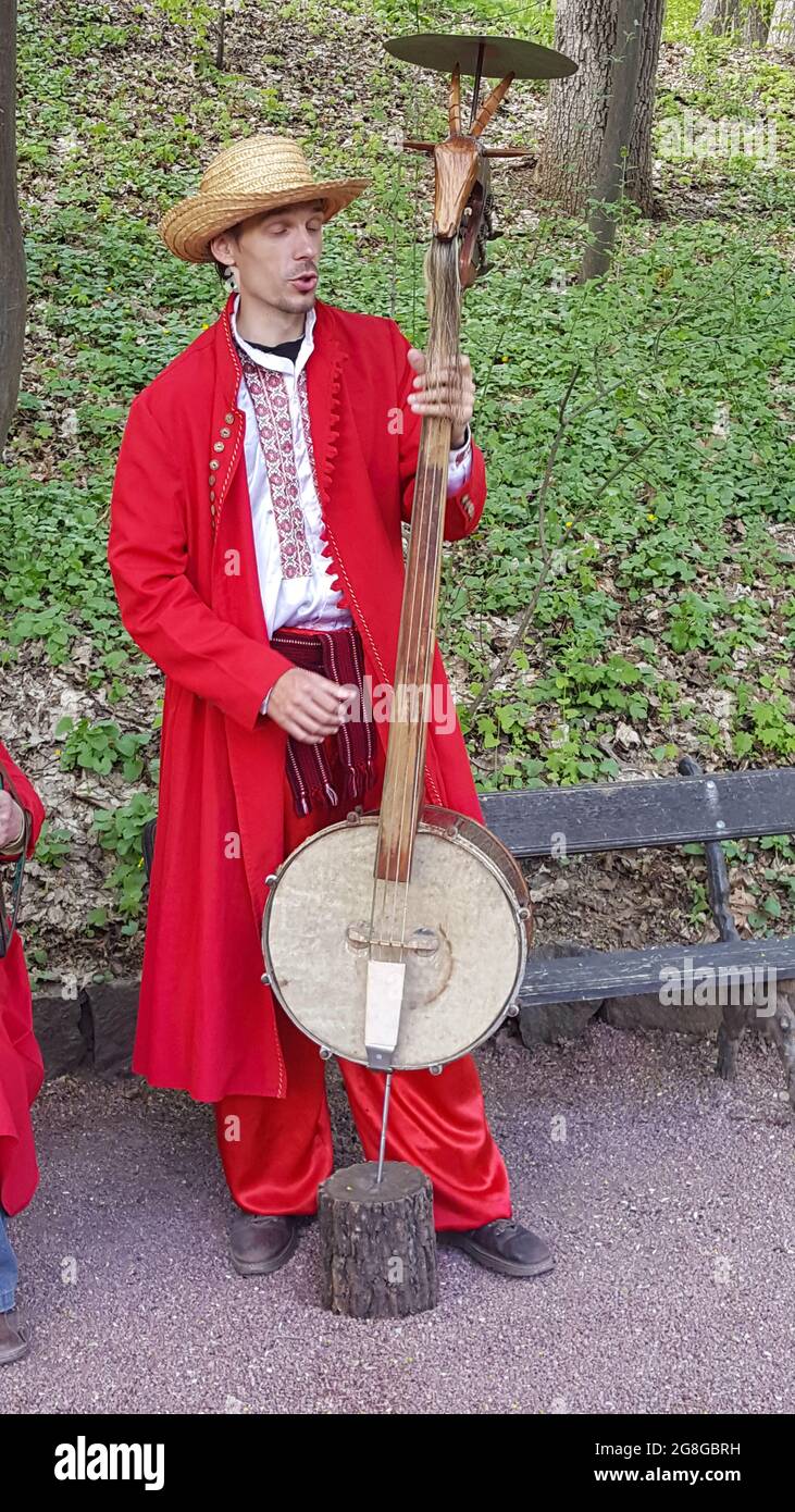 Sofievsky Park, Ukraine - 04.23.2018: A group of musicians in Ukrainian national costumes. Clothing and musical instruments are reminiscent of the mol Stock Photo
