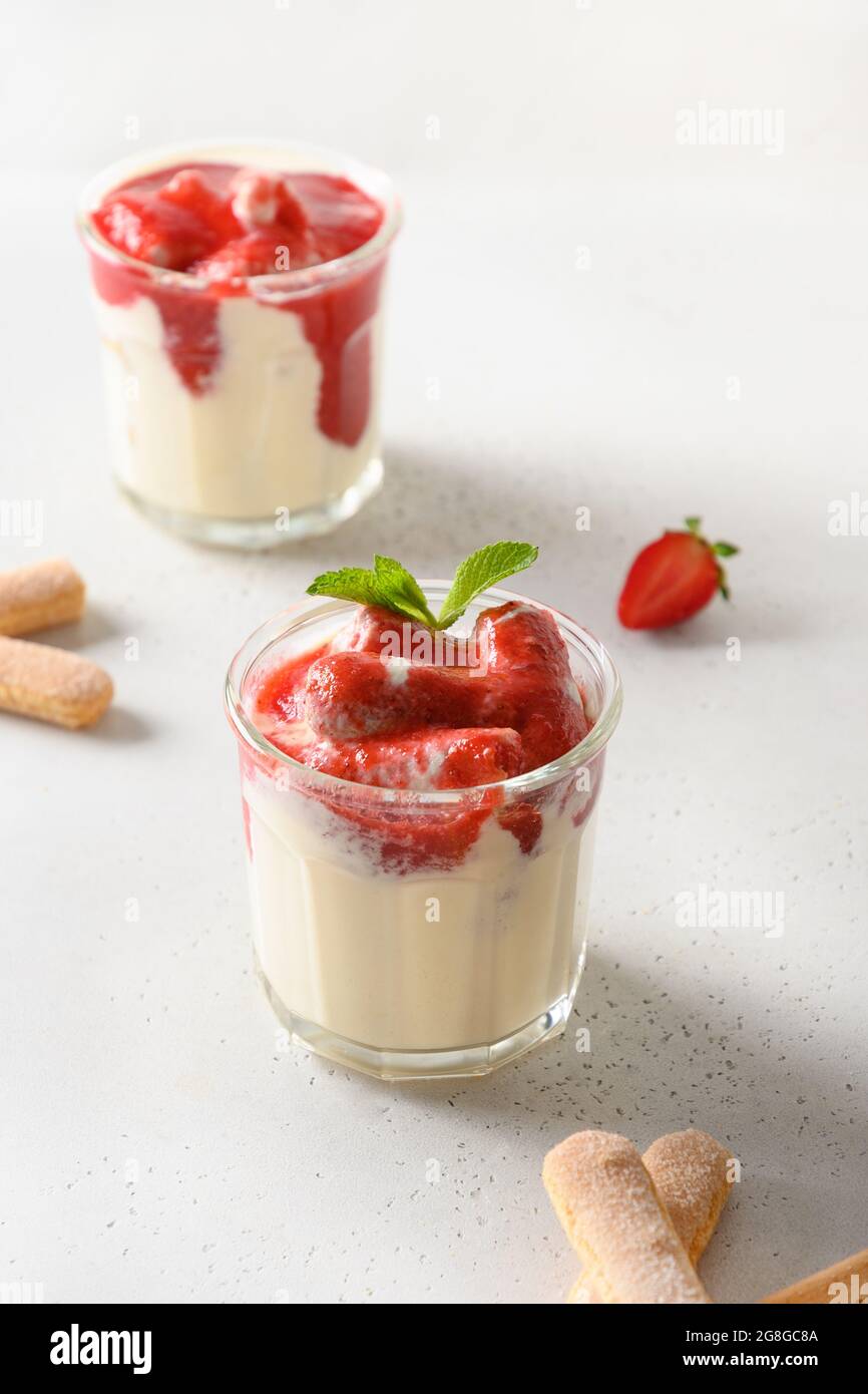 Layered summer dessert in glass jars with cookie savoyardi, mascarpone and whipped  cream decorated strawberries. Close up. Italian tiramisu with summe Stock  Photo - Alamy