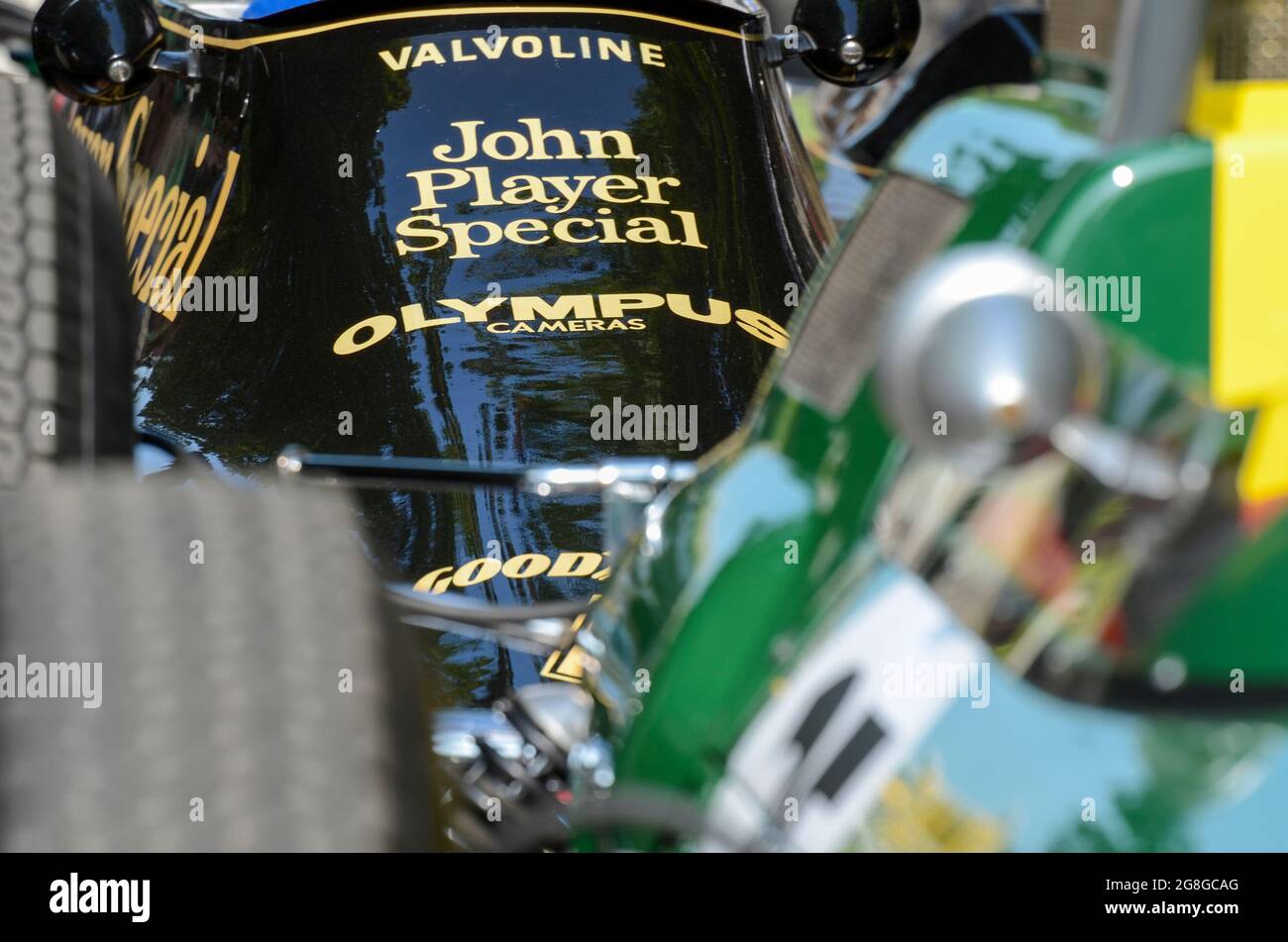 Detail of a 1970s Lotus 79 with John Player Special sponsorship behind a 1960s vintage green Lotus at the Goodwood Festival of Speed event, UK Stock Photo