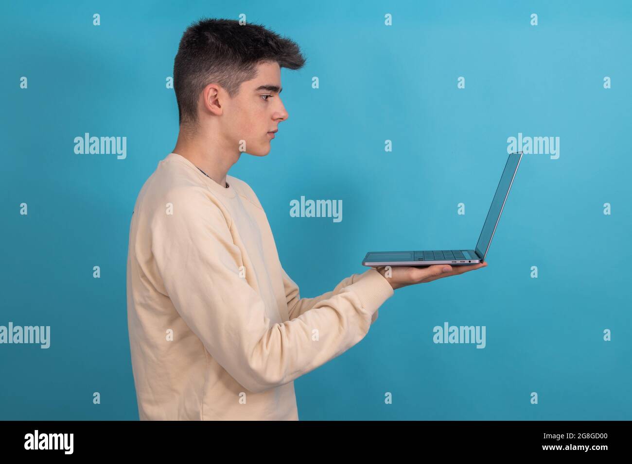 student teenager with laptop isolated from profile with space Stock