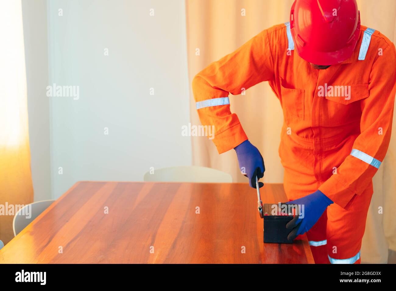 African American mechanic working on a house Stock Photo