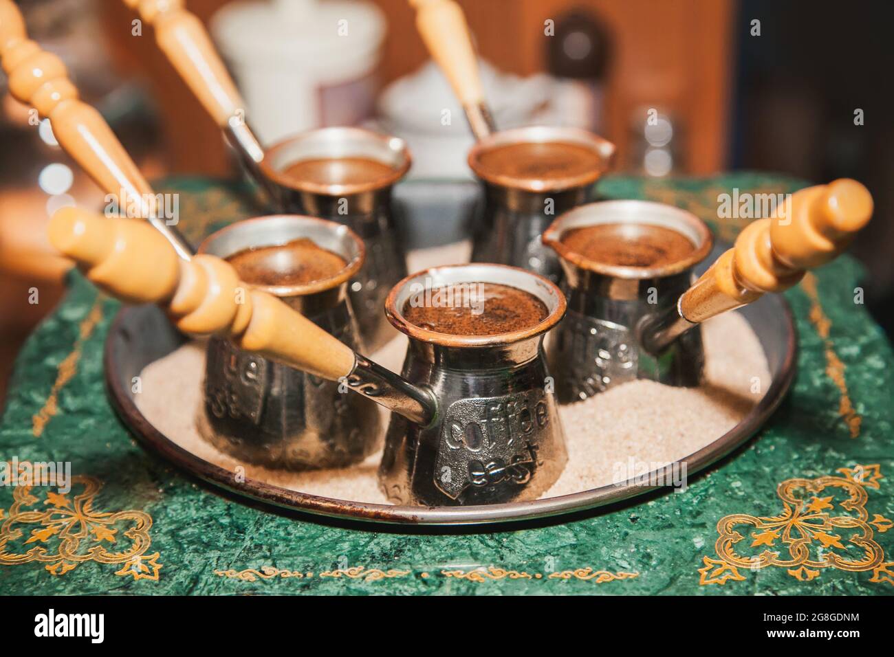 Turkish coffee brewed on sand in cezve. Oriental, east coffee Stock