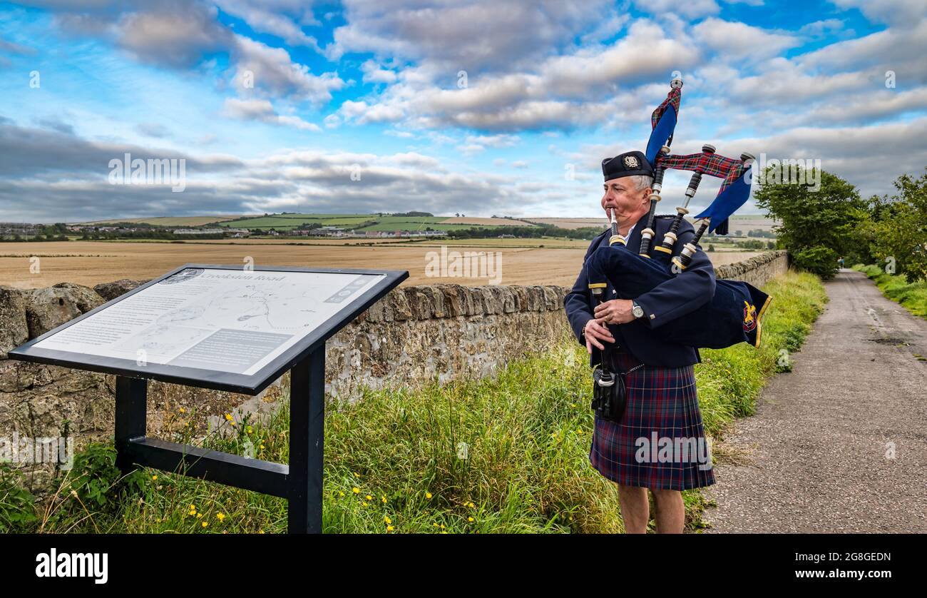 A piper playing bagpipes at the Battle of Pinkie Cleugh battlefield, commemoration, Musselburgh, East Lothian, Scotland, UK Stock Photo