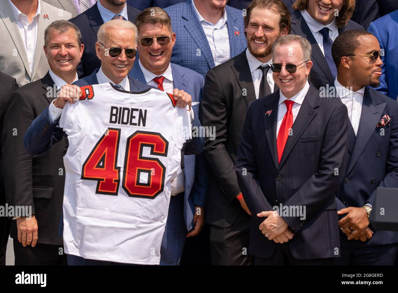 Washington, United States. 20th July, 2021. President Joe Biden, left, holds a number 46 jersey handed to him by Super Bowl Champions Tampa Bay Buccaneers owner Bryan Glazer, right, on the South Lawn of the White House in Washington, DC on Tuesday, July 20, 2021. Tampa Bay Defeated Kansas City Chiefs 31-9. Photo by Ken Cedeno/UPI Credit: UPI/Alamy Live News Stock Photo