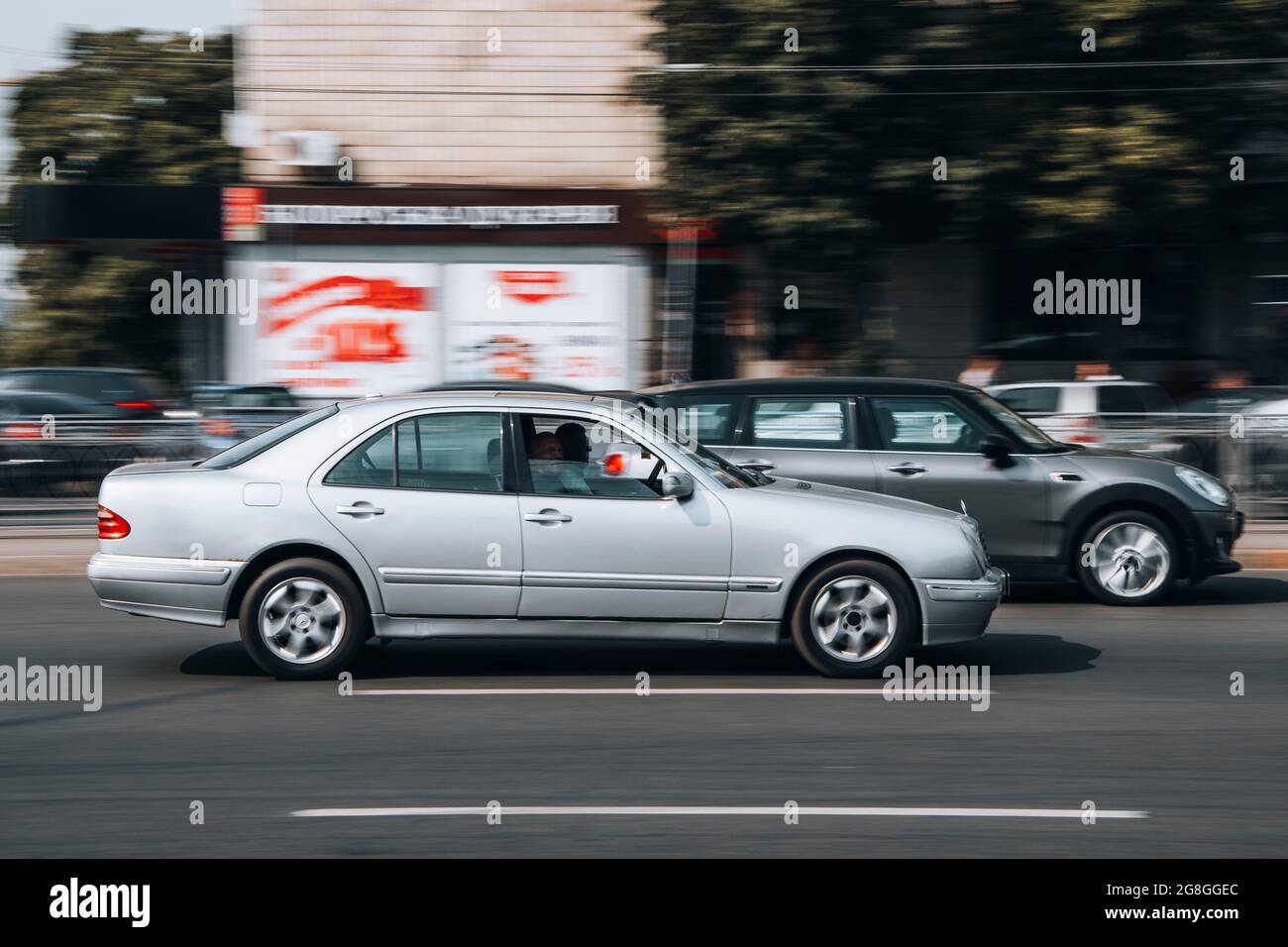 Ukraine, Kyiv - 16 July 2021: Silver Mercedes-Benz E-Class car moving on the street. Editorial Stock Photo