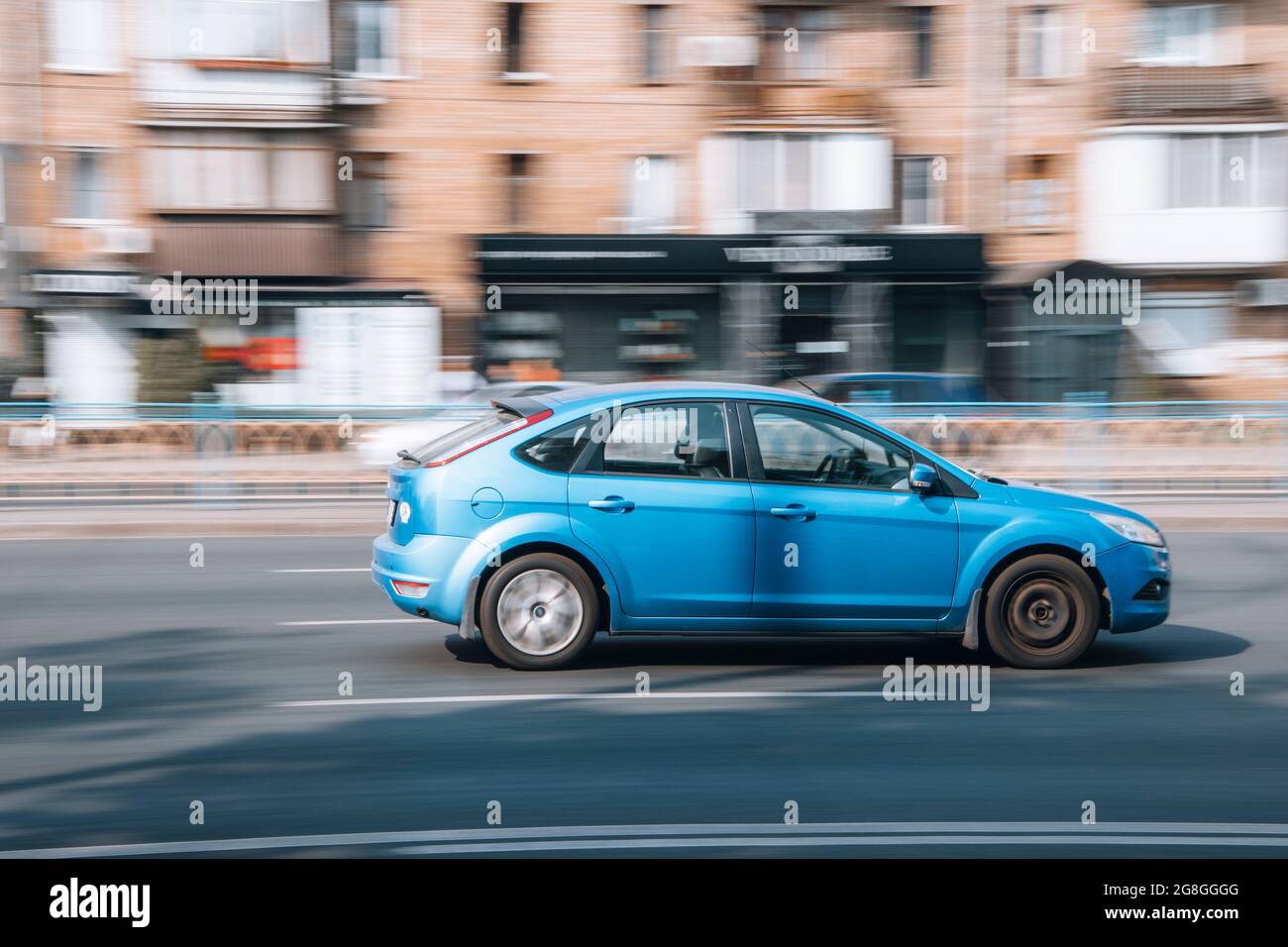 Ukraine, Kyiv - 16 July 2021: Light Blue Ford Focus car moving on the street. Editorial Stock Photo