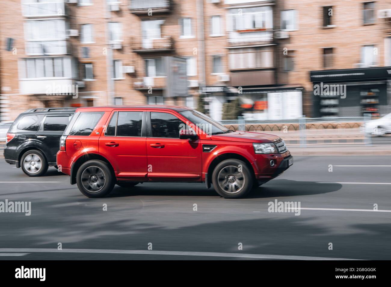 Ukraine, Kyiv - 16 July 2021: Red Land Rover Freelander car moving on the street. Editorial Stock Photo