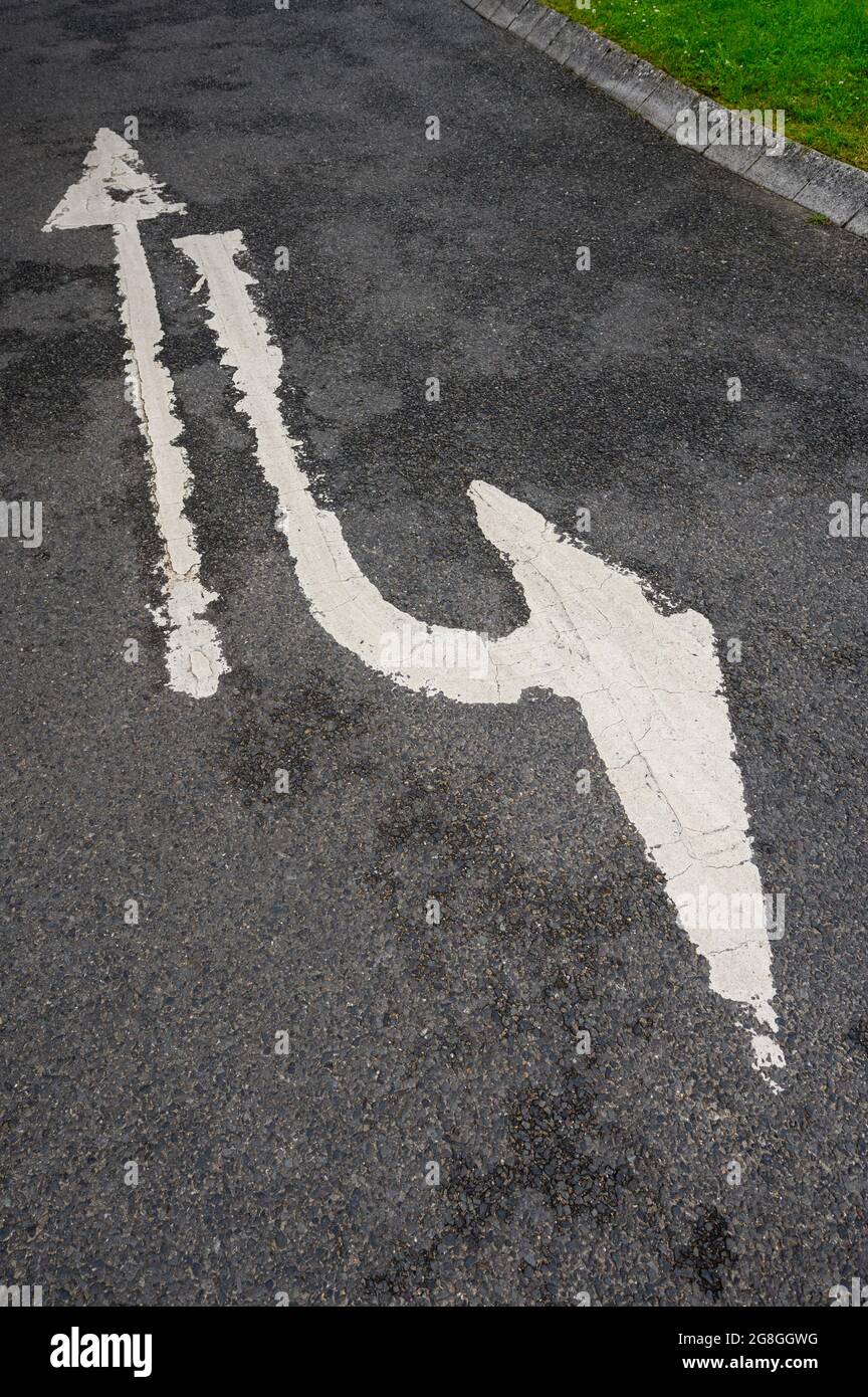 Unusual direction arrows on a road surface. Stock Photo