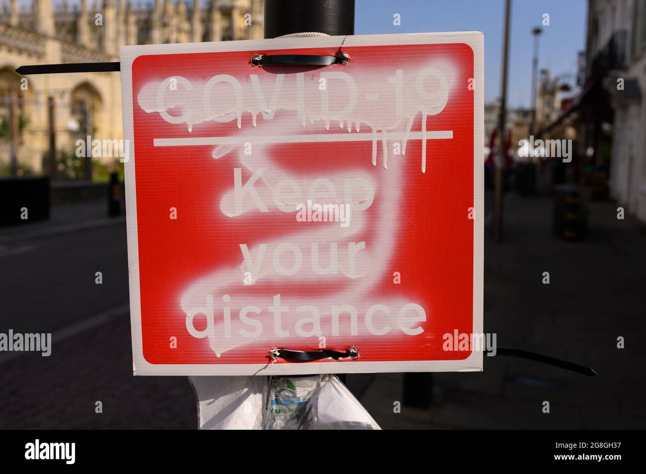 Defaced or vandalised COVID-19 social distancing sign. Stock Photo