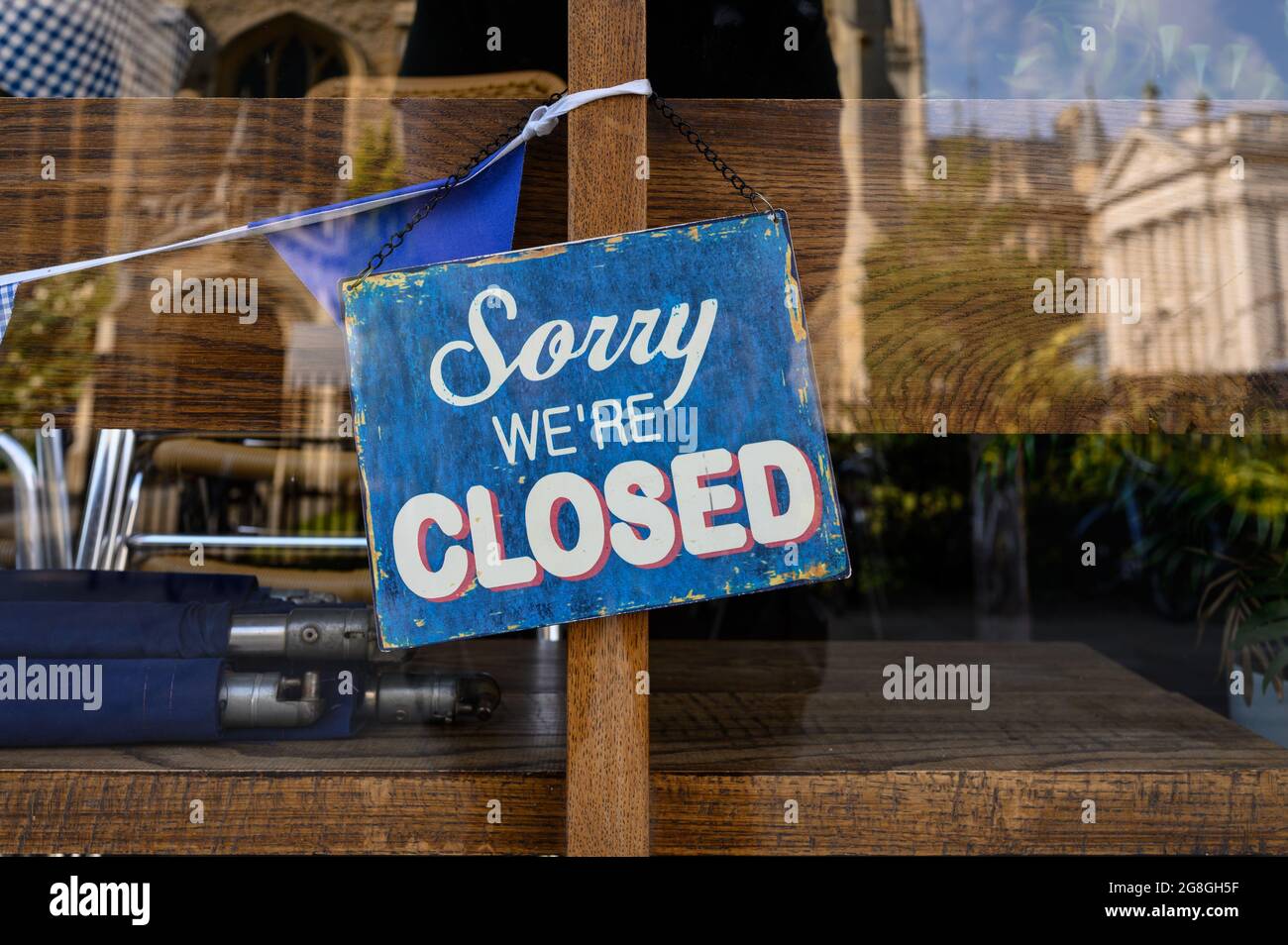 Sign in a shop window saying Sorry We're Closed. Stock Photo