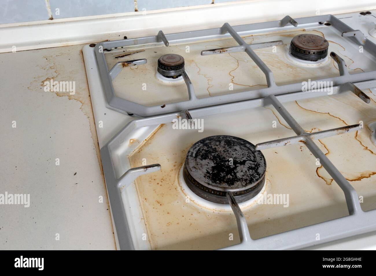 Dirty gas stove cooking oil stains on gas stove in kitchen.An Unclean