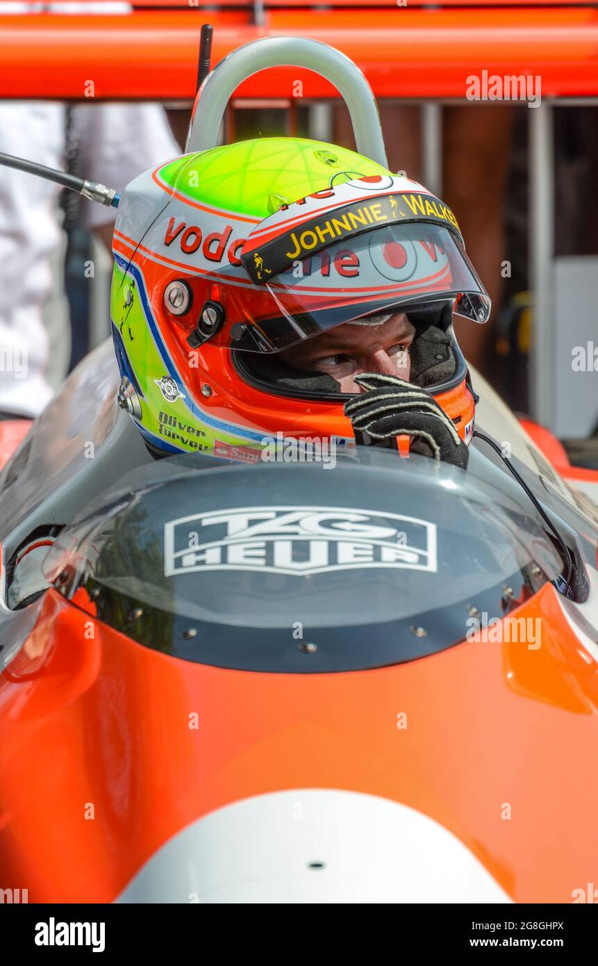 Oliver Turvey, racing driver, preparing to race Ayrton Senna's historic McLaren MP4/4 at the Goodwood Festival of Speed event, UK. In car Stock Photo
