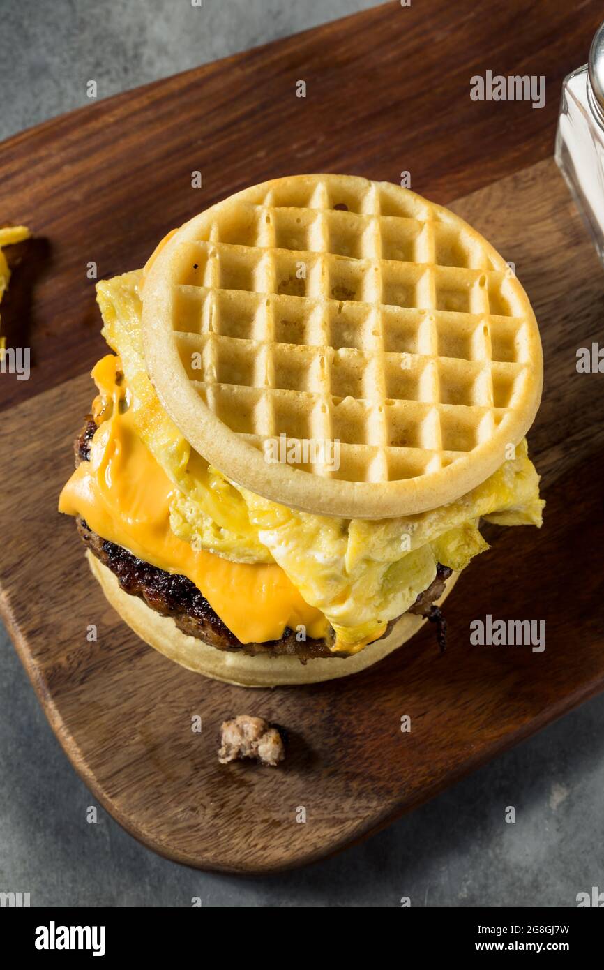 Homemade Waffle Breakfast Egg Sandwich with Cheese and Sausage Stock