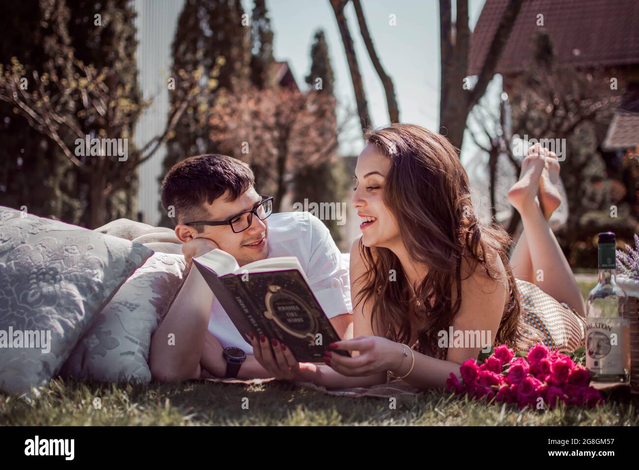 Young couple reading on a picknick date Stock Photo
