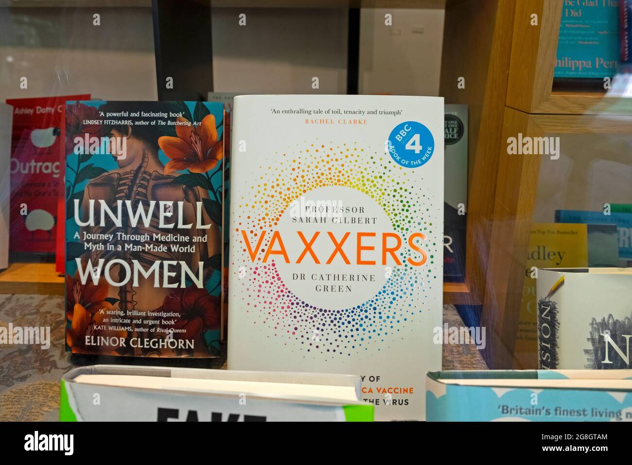 Vaxxers book front cover by authors Sarah Gilbert and Catherine Green and Unwell Women by author Elinor Cleghorn in Waterstones bookshop window UK Stock Photo