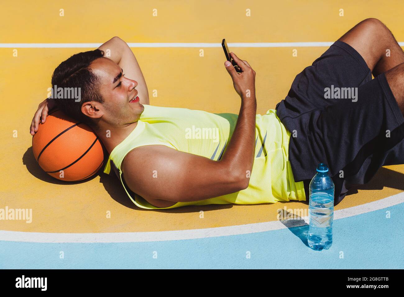 Man dribbling basketball in park hires stock photography and images