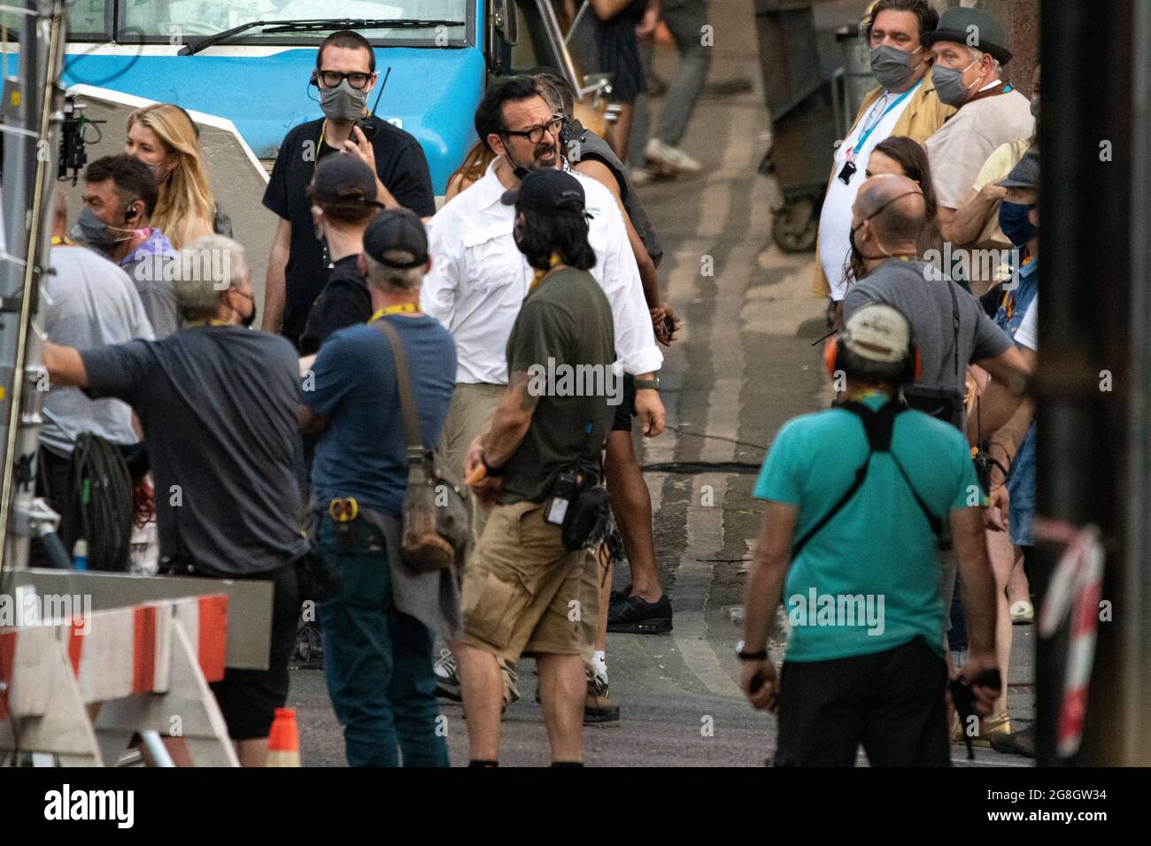 Glasgow, Scotland, UK. 20th July, 2021. PICTURED: The films producer and director, James Mangold seen in white and dark glasses seen in between takes on set. Filming on the set of Indiana Jones 5 in the middle of Glasgow city centre as the Hollywood blockbuster sets up Glasgow as New York City. A full production can be seen, with a large cast, producers and extras. The city centre has been changed so that all the shop fronts and building look like 1959 America. Credit: Colin Fisher/Alamy Live News Stock Photo