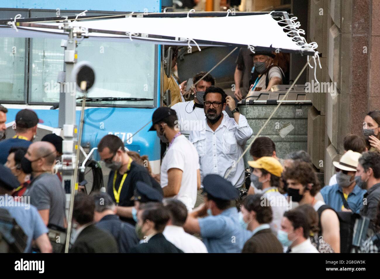 Glasgow, Scotland, UK. 20th July, 2021. PICTURED: The films producer and director, James Mangold seen in white and dark glasses seen in between takes on set. Filming on the set of Indiana Jones 5 in the middle of Glasgow city centre as the Hollywood blockbuster sets up Glasgow as New York City. A full production can be seen, with a large cast, producers and extras. The city centre has been changed so that all the shop fronts and building look like 1959 America. Credit: Colin Fisher/Alamy Live News Stock Photo
