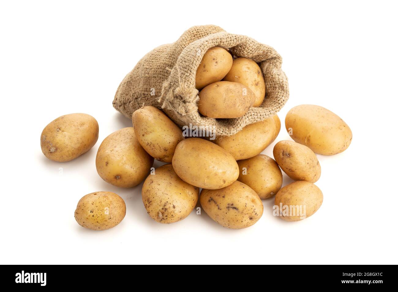 New potatoes in burlap sack isolated on white background. Raw potato Stock Photo