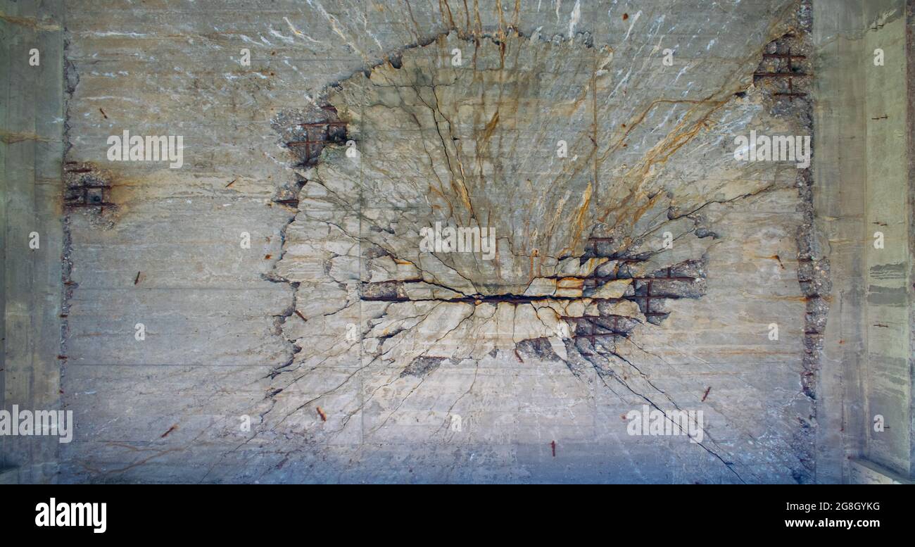 Crack in a concrete massive crack. Something exploded on the other side