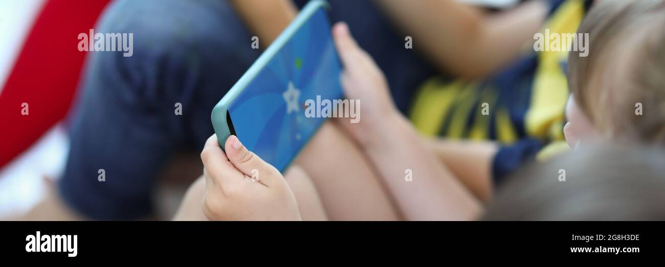 Little children playing game on the phone close-up Stock Photo