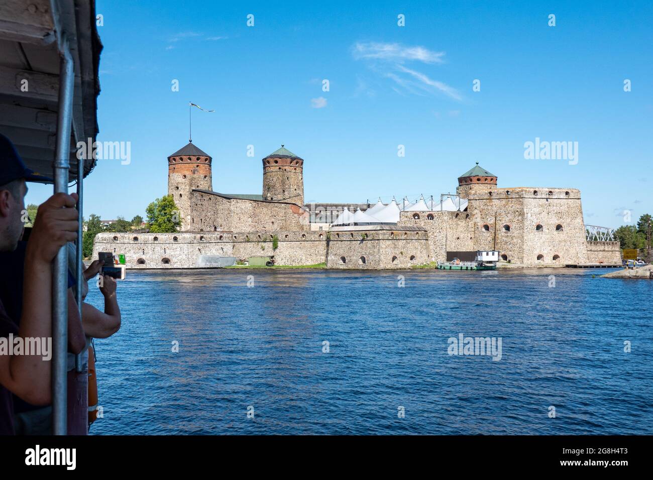 tourists-on-a-lake-saimaa-cruise-taking-pictures-of-medieval-stone