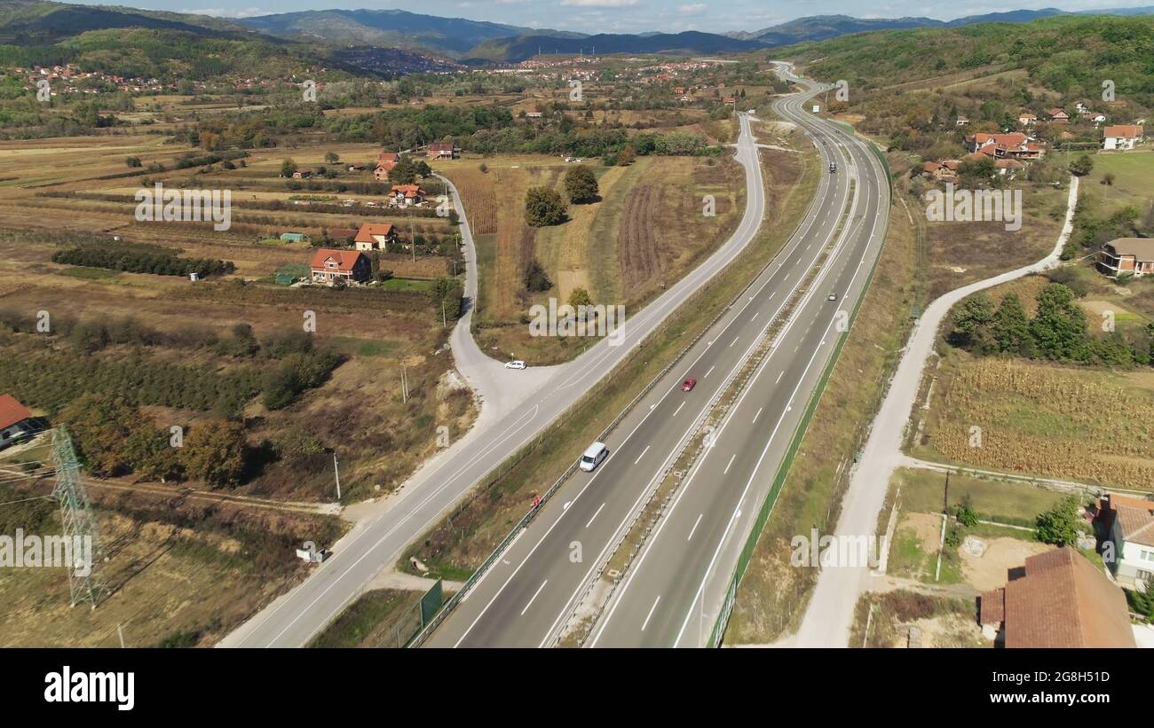 Road curves through rural landscape Stock Photo