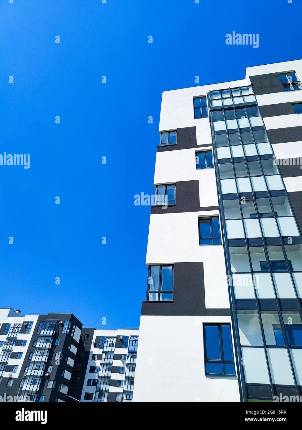 Fragment of modern apartment building opposite blue sky Stock Photo Alamy