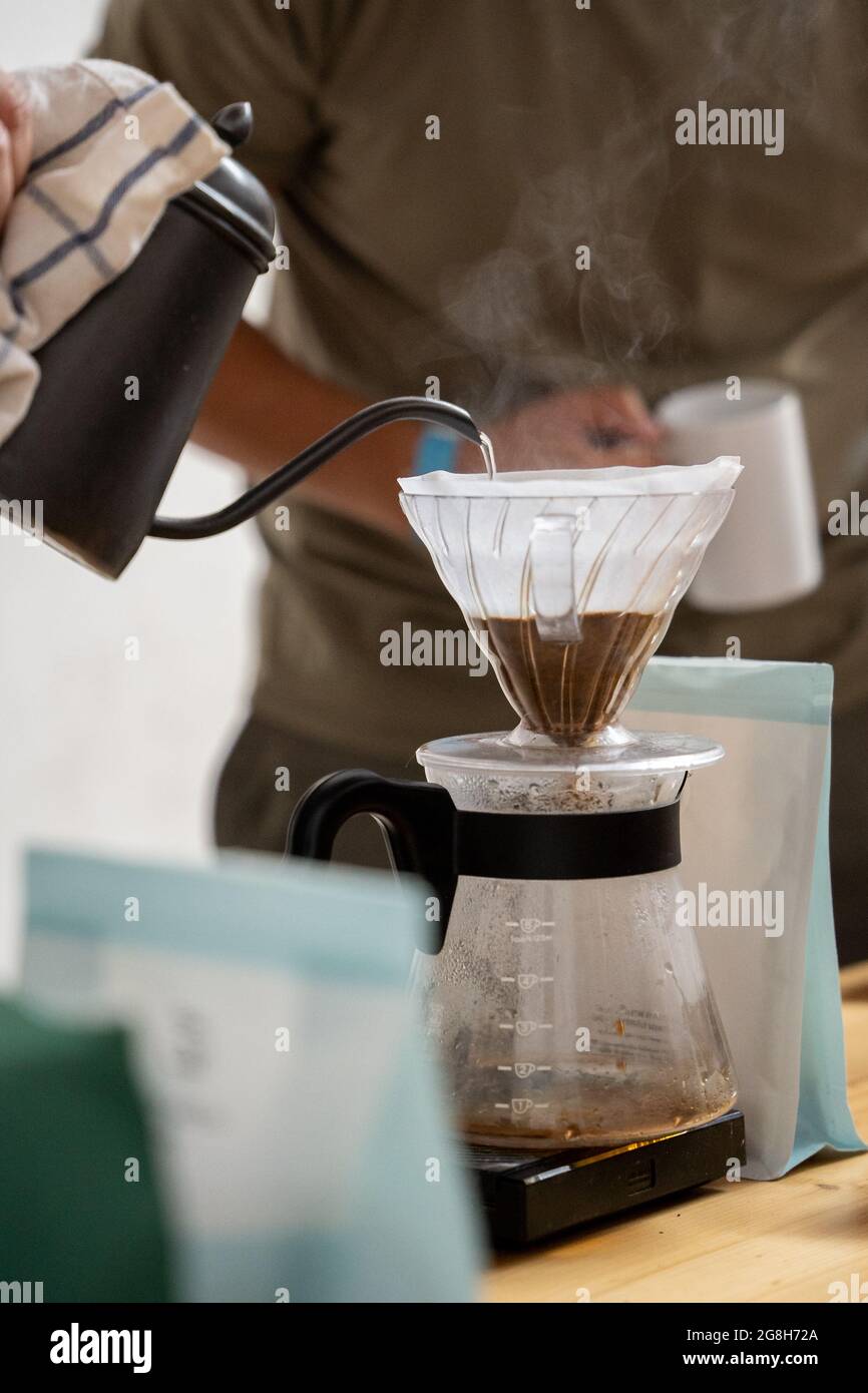 Preparing V60 coffee, pouring hot water over coffee, filter coffee, coffee drip Stock Photo Alamy
