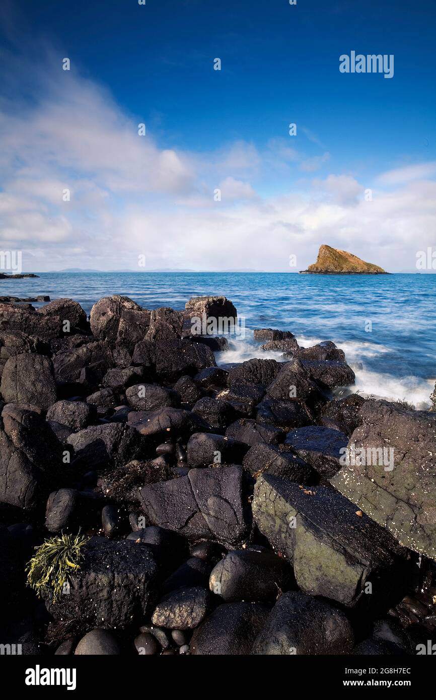 Seascape view captured in the area of Duntulm Castle with rocky shore line and a small island in the near distance.Scotland, Isle of Sky - UK. Stock Photo