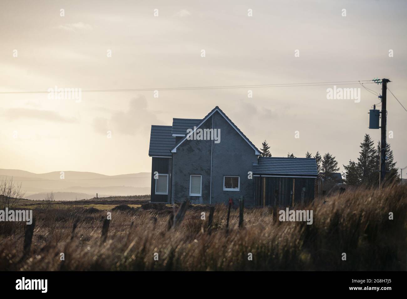 Landscape view of a house and fields at sunset in rural Scotland, Isle