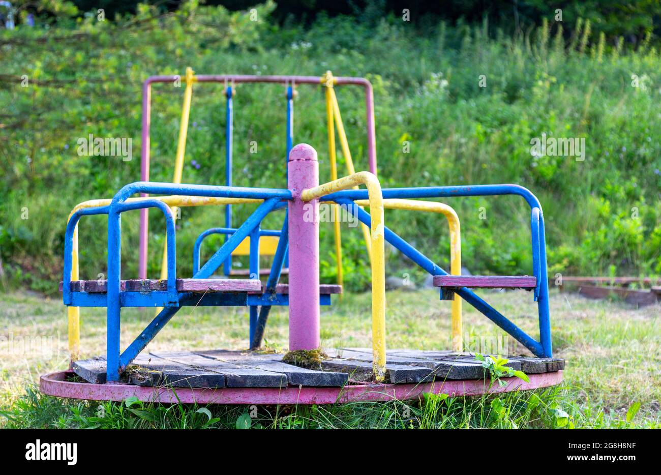 Abandoned playground. rusty non-working carousel. Children's games. Stock Photo