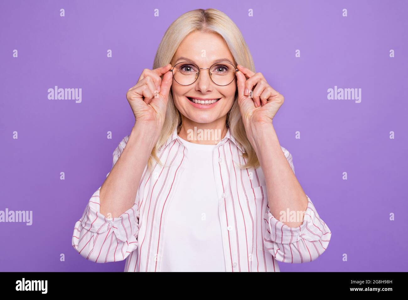 photo-of-adorable-sweet-mature-woman-dressed-pink-shirt-arms-glasses