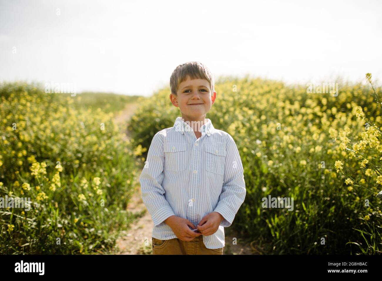 Young Boy Standing in Wildflower Field Stock Photo - Alamy