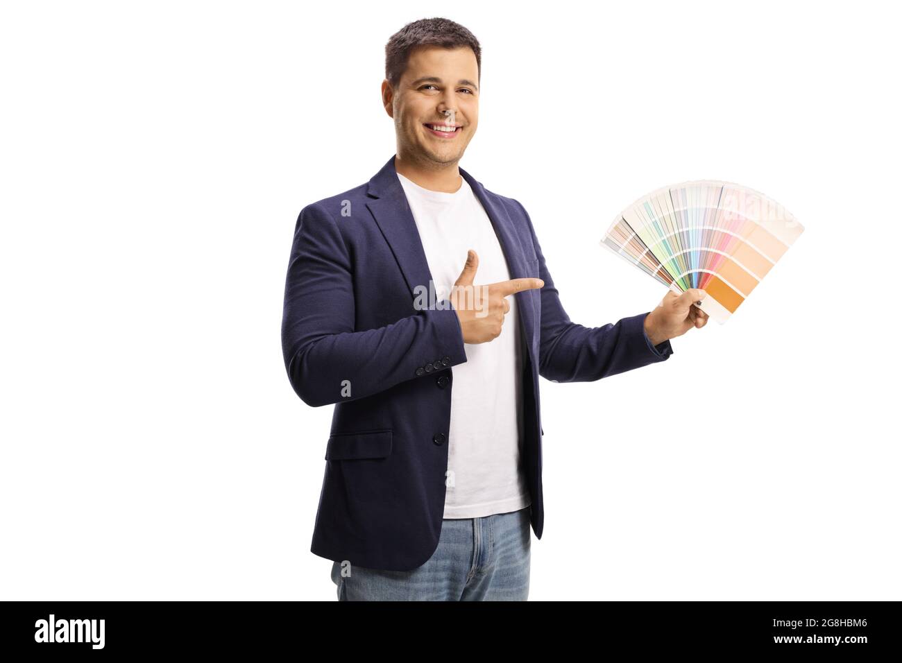 Smiling young man holding a color swatch chart and pointing isolated on white background Stock Photo