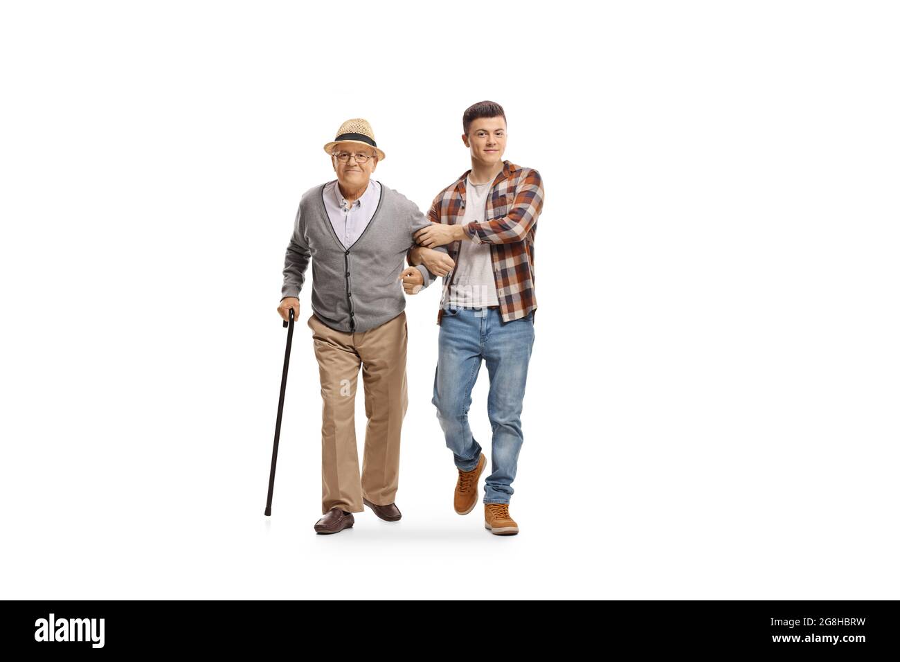 Young man helping an old man with a walking cane isolated on white ...