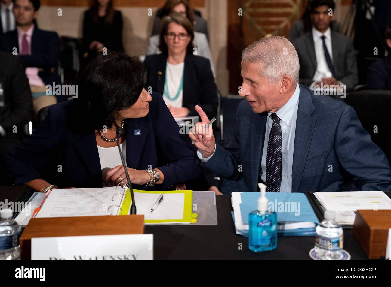 Washington DC, USA. 20th July, 2021. Anthony Fauci (R), director of the U.S. National Institute of Allergy and Infectious Diseases, speaks to Rochelle Walensky, director of the U.S. Centers for Disease Control and Prevention, prior to a Senate Health, Education, Labor and Pensions Committee hearing titled 'The Path Forward: A Federal Perspective on the COVID-19 Response' in Washington, DC, the United States, on July 20, 2021. Anthony Fauci has recently said that he believes the natural origins theory of the novel coronavirus is still 'the most likely.' (Stefani Reynolds/Pool via Credit: Xinhua Stock Photo