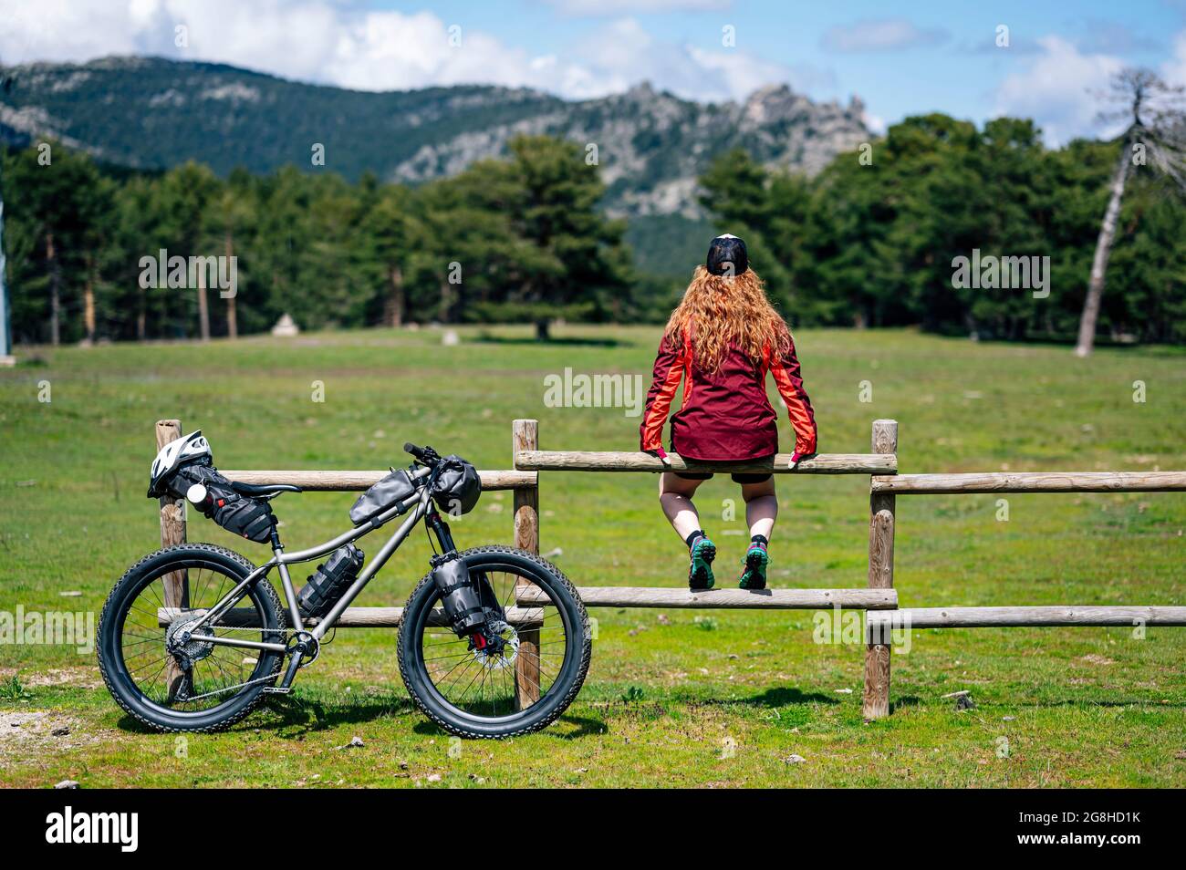 Woman enjoying with a mountain bike in nature, practices bikepacking Stock Photo