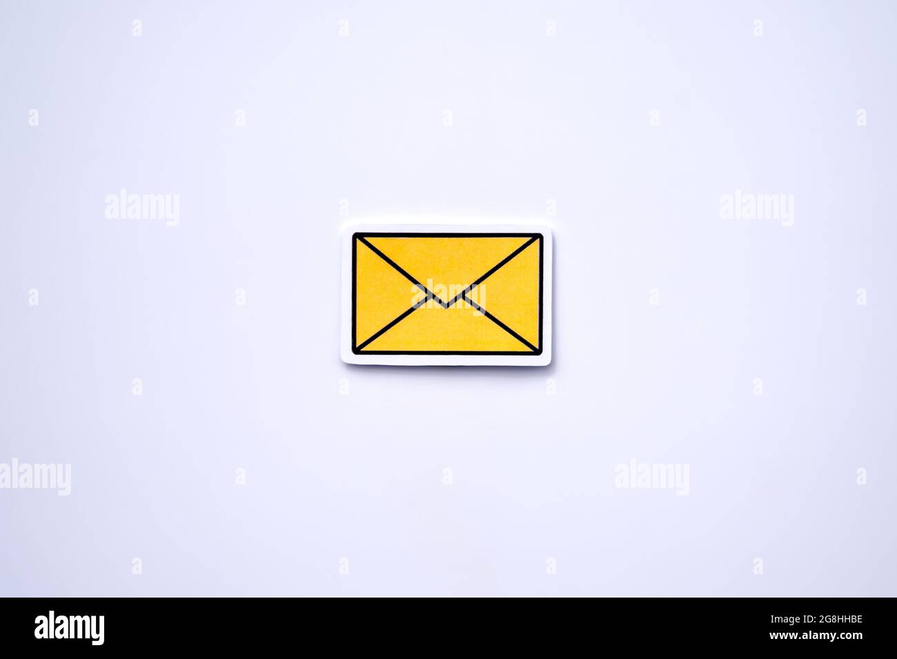 Yellow message sign or envelope icon against a white background Stock Photo